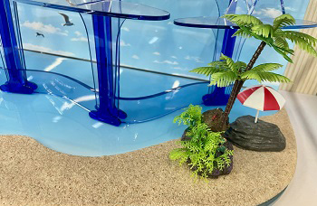 Miniature beach palm tree decor integrated into acrylic baseboard
